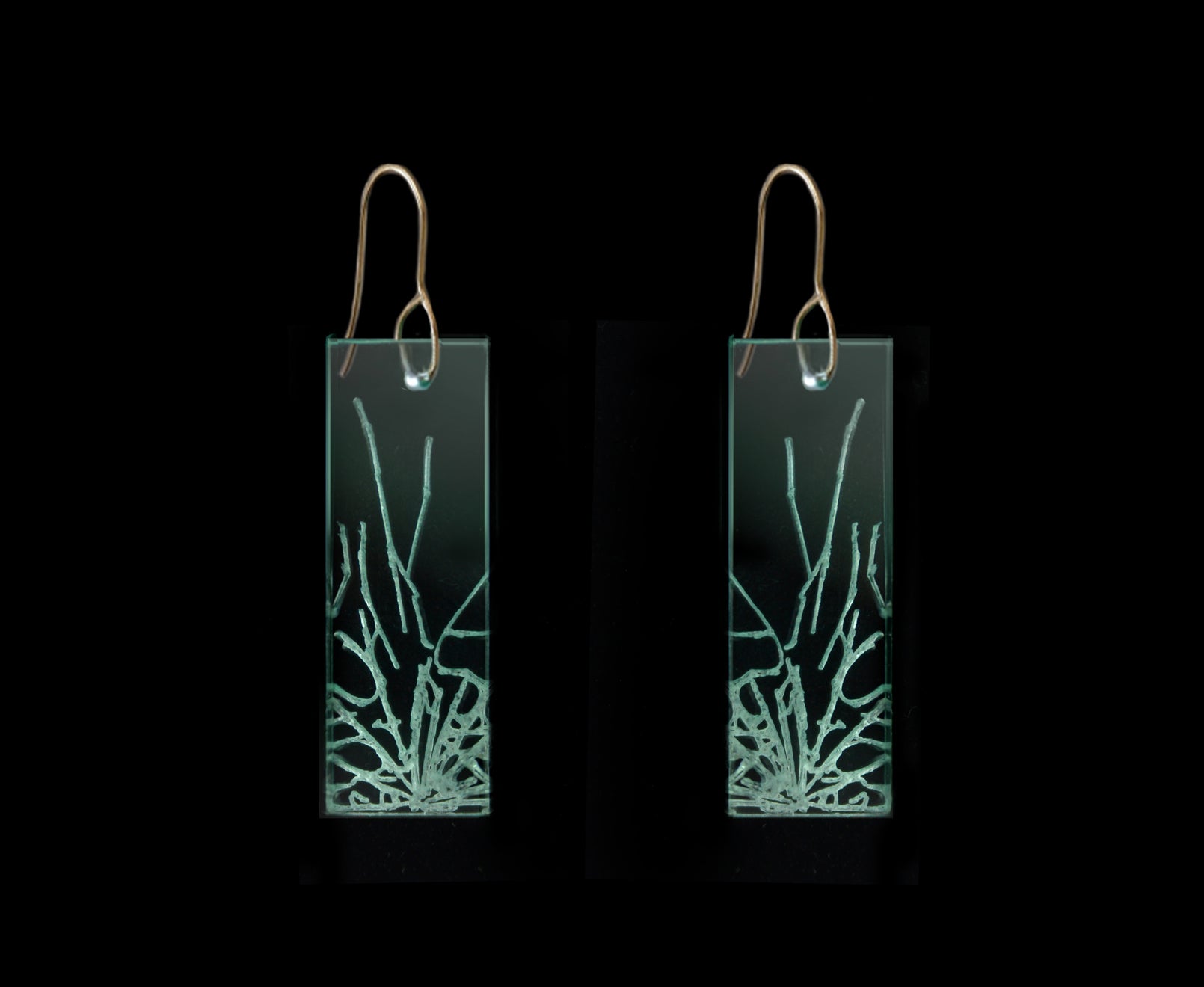 Statement earrings with shattered glass appearance, representing breaking the glass ceiling, medium length design with gold metal.