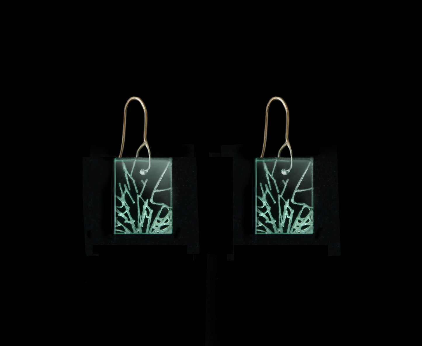 Statement earrings with shattered glass appearance, representing breaking the glass ceiling, short rectangle design with gold metal hook.