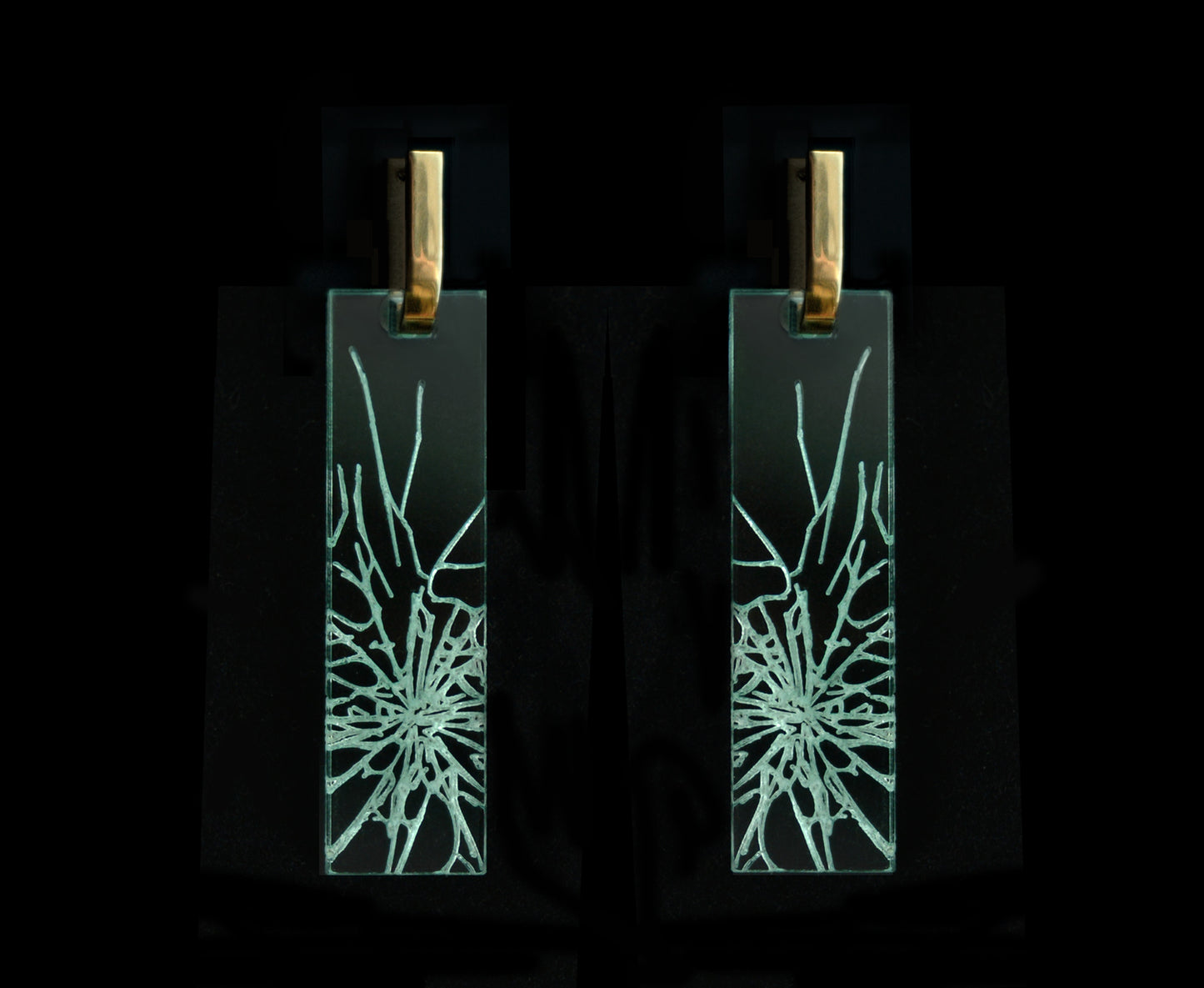 Bold acrylic earrings with a faux fractured glass, symbolizing a shattered glass ceiling, long rectangle design with gold metal.