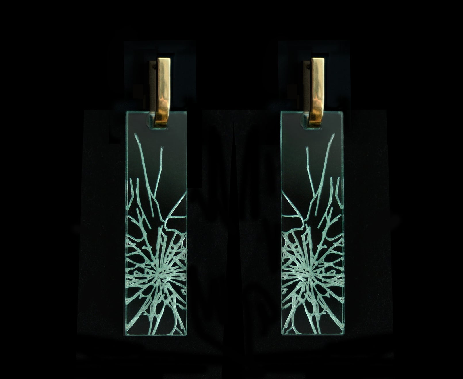Bold acrylic earrings with a faux fractured glass, symbolizing a shattered glass ceiling, long rectangle design with gold metal.