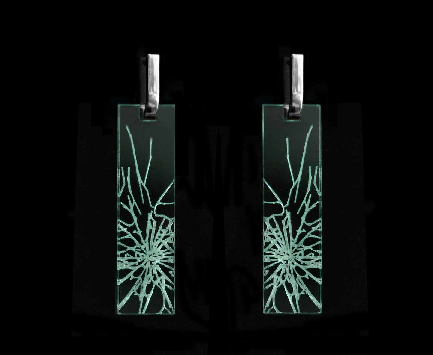 Bold acrylic earrings with a faux fractured glass, symbolizing a shattered glass ceiling, long rectangle design with silver metal.