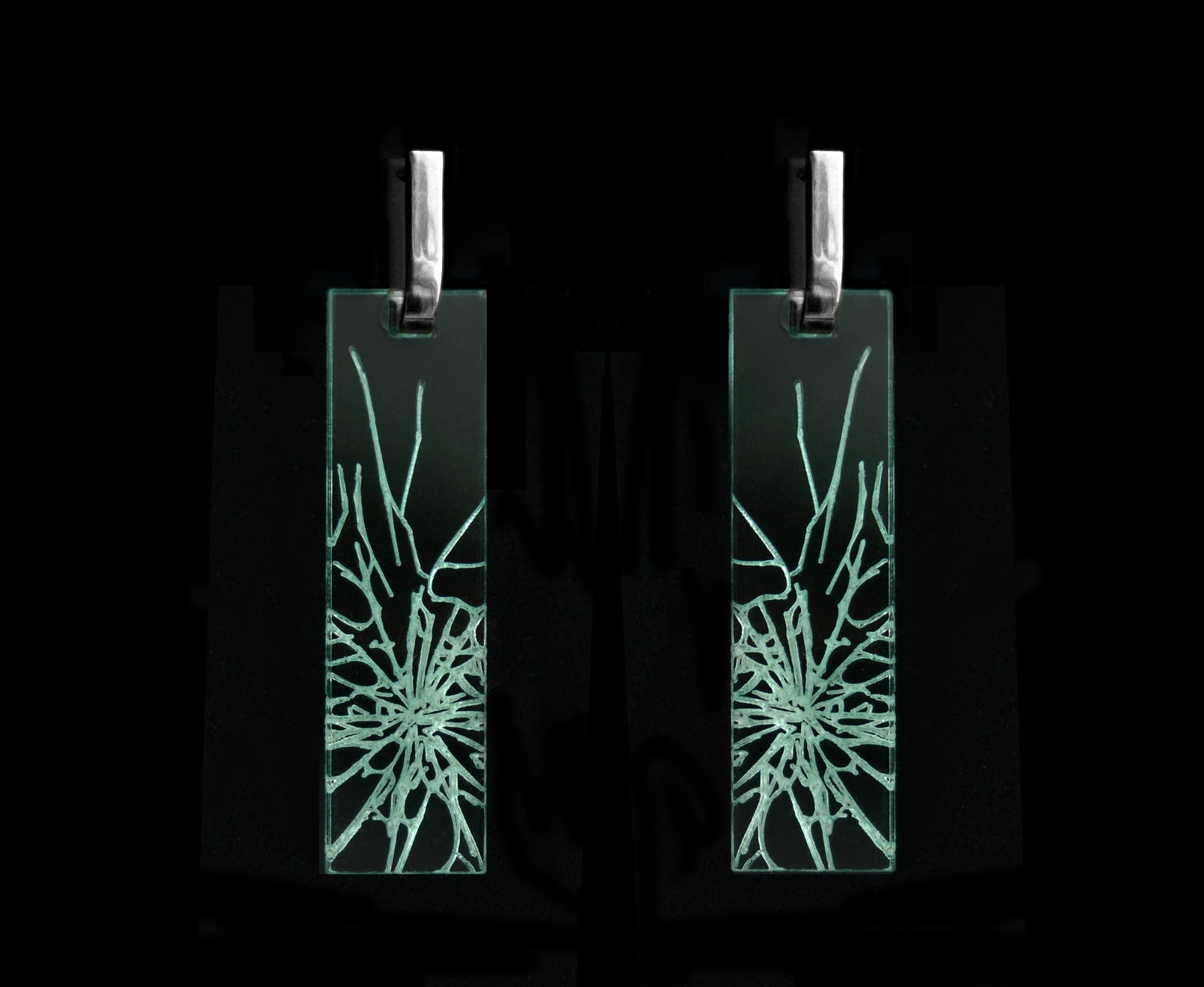 Bold acrylic earrings with a faux fractured glass, symbolizing a shattered glass ceiling, long rectangle design with silver metal.