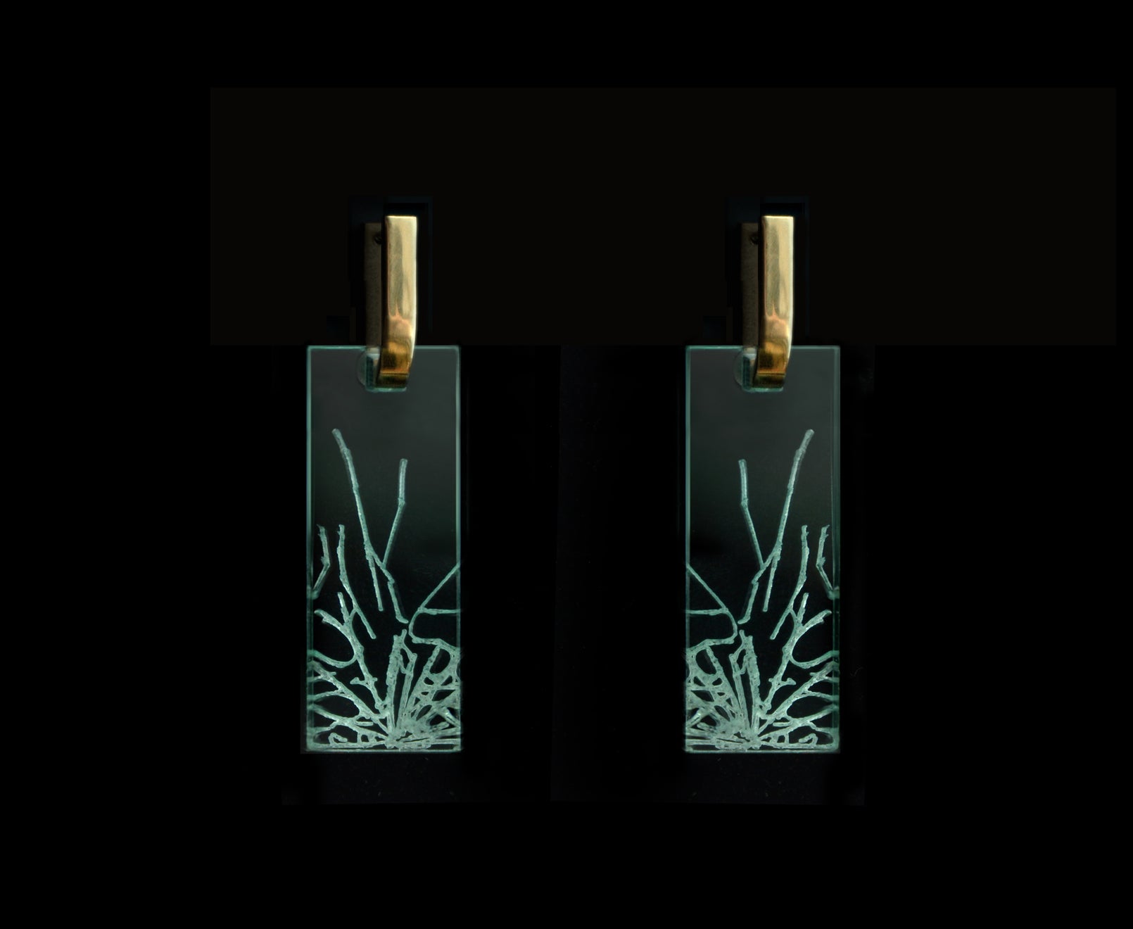 Bold acrylic earrings with a faux fractured glass, symbolizing a shattered glass ceiling, mid-length rectangle design with gold metal.