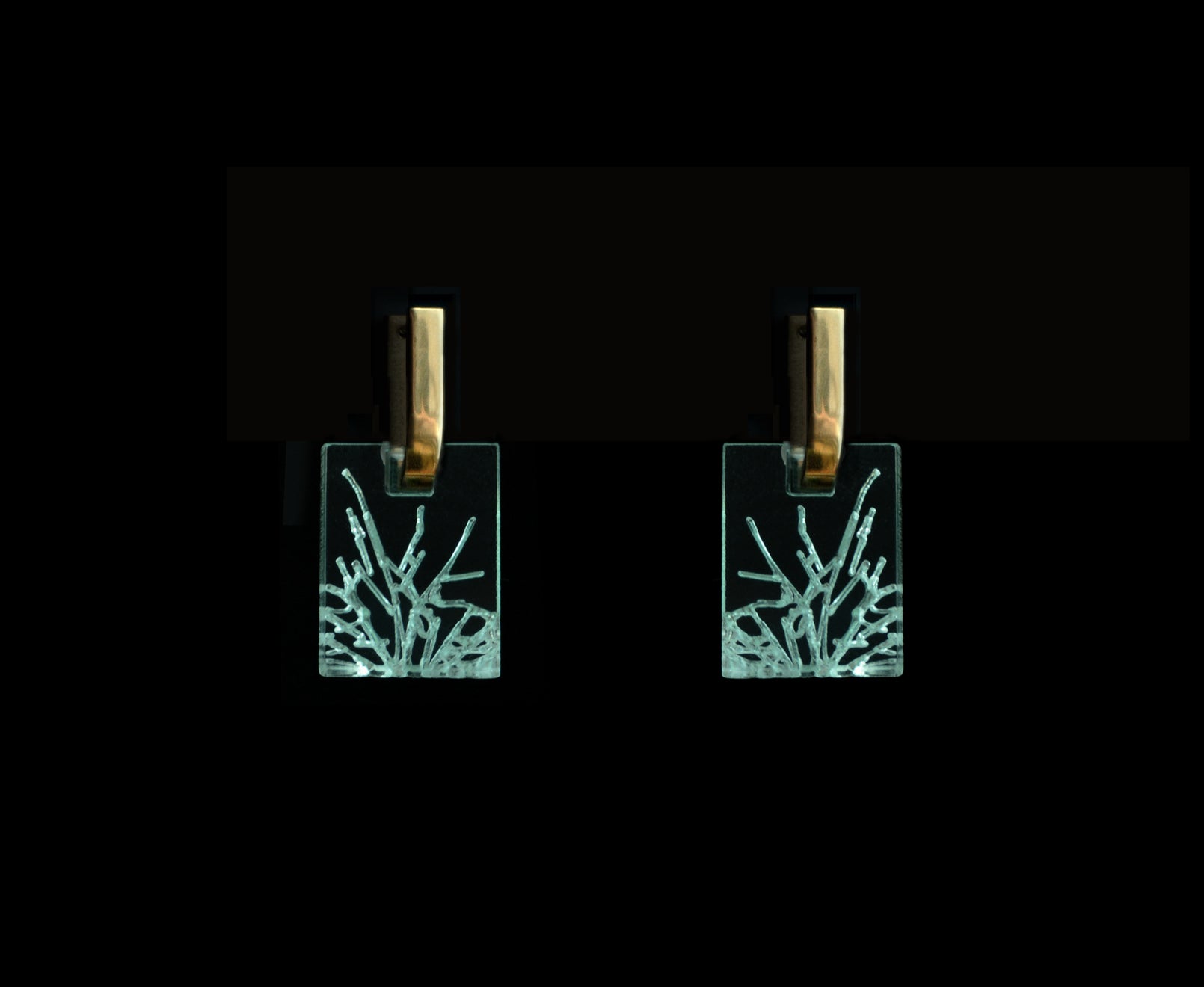 Bold acrylic earrings with a faux fractured glass, symbolizing a shattered glass ceiling, short rectangle design with gold metal.