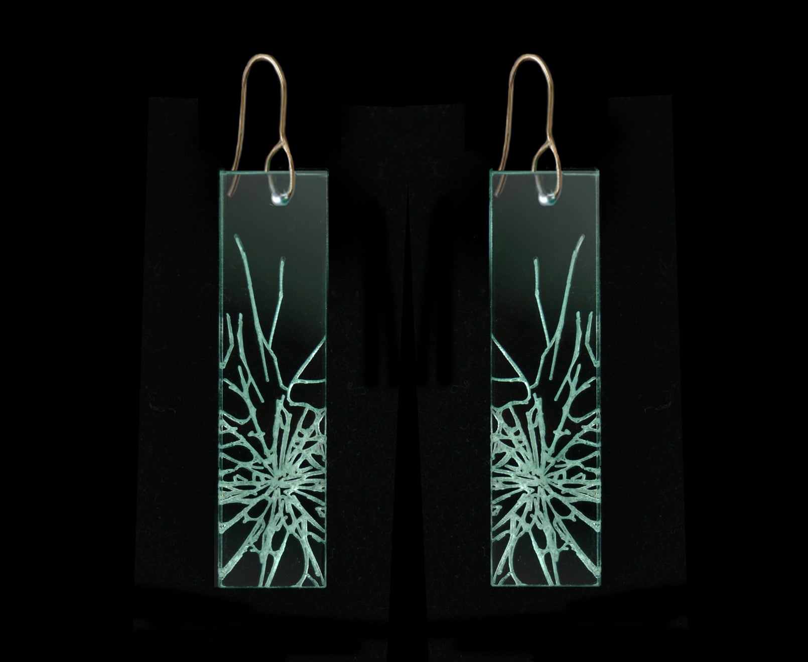 Statement earrings with shattered glass appearance, representing breaking the glass ceiling, long rectangle design with gold metal.