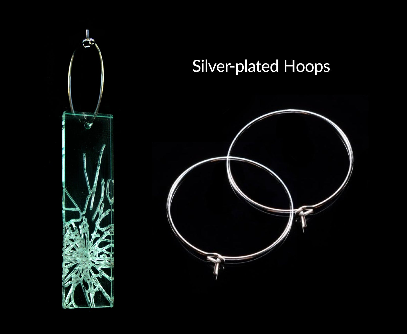 Laser-cut earrings in a shattered glass shape symbolizing gender equality, showing silver-plated earring hoops.