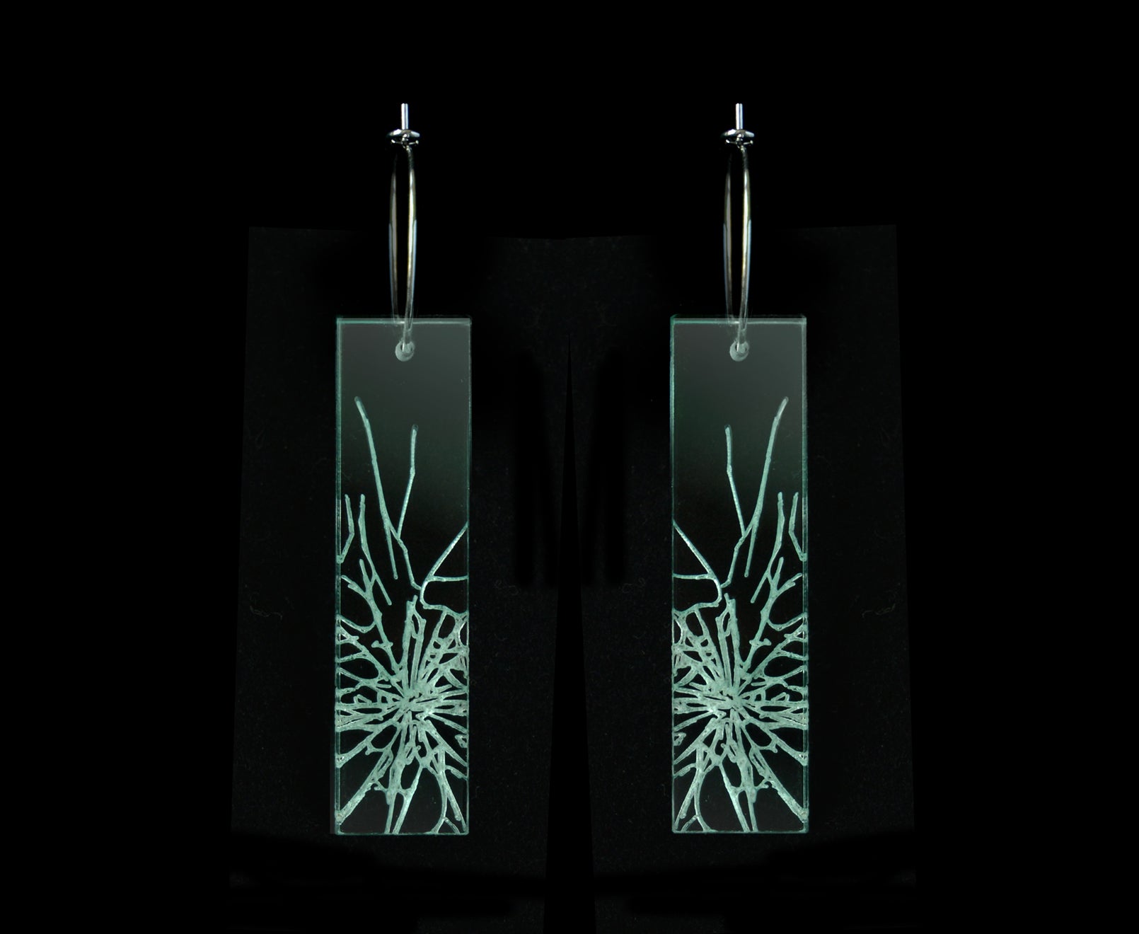 Laser-cut earrings in a shattered glass shape symbolizing gender equality, long rectangle style.