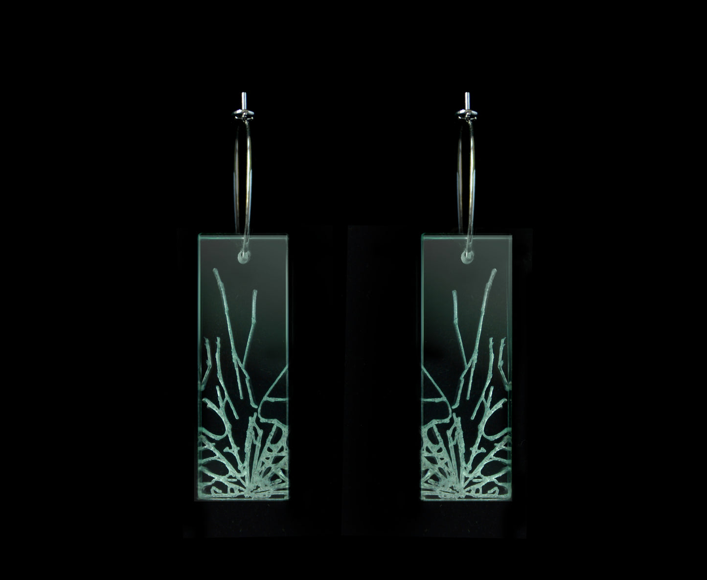 Laser-cut earrings in a shattered glass shape symbolizing gender equality, mid-length rectangle style.