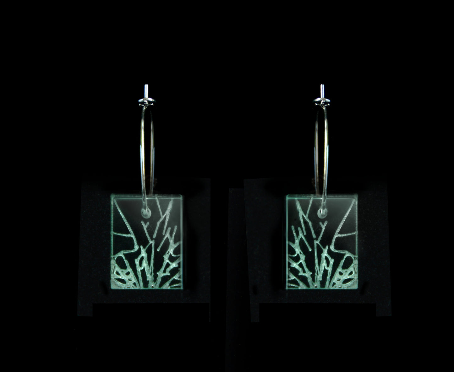 Laser-cut earrings in a shattered glass shape symbolizing gender equality, short rectangle style.