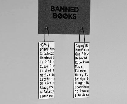 Bold literary protest hoops made with laser-cut recycled acrylic and stainless steel ear wires