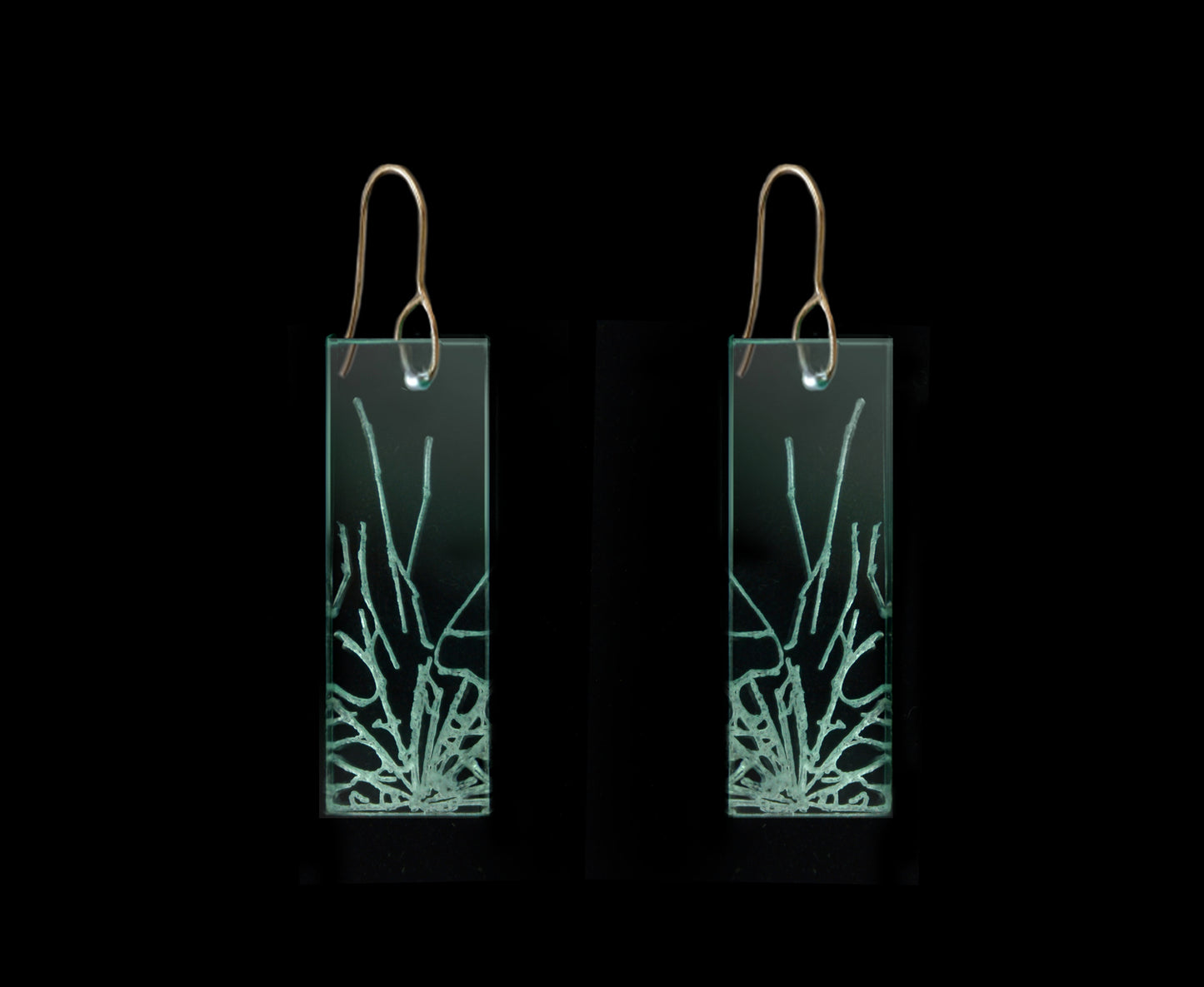 Statement earrings with shattered glass appearance, representing breaking the glass ceiling, medium length design with gold metal.