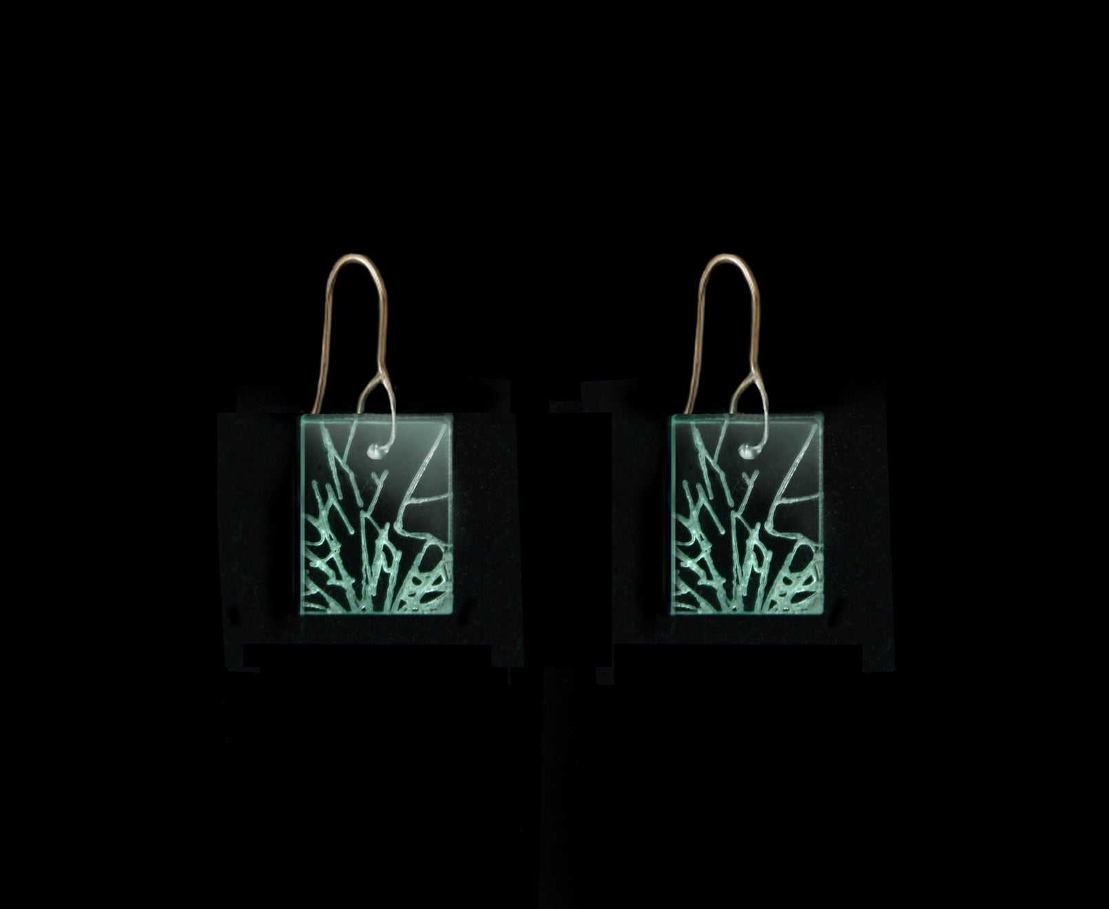 Statement earrings with shattered glass appearance, representing breaking the glass ceiling, short rectangle design with gold metal hook.