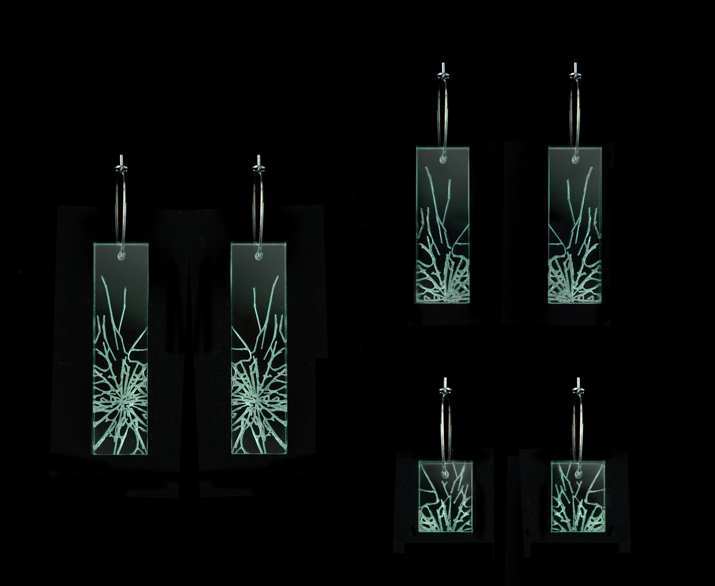 Laser-cut earrings in a shattered glass shape symbolizing gender equality, three different lengths.