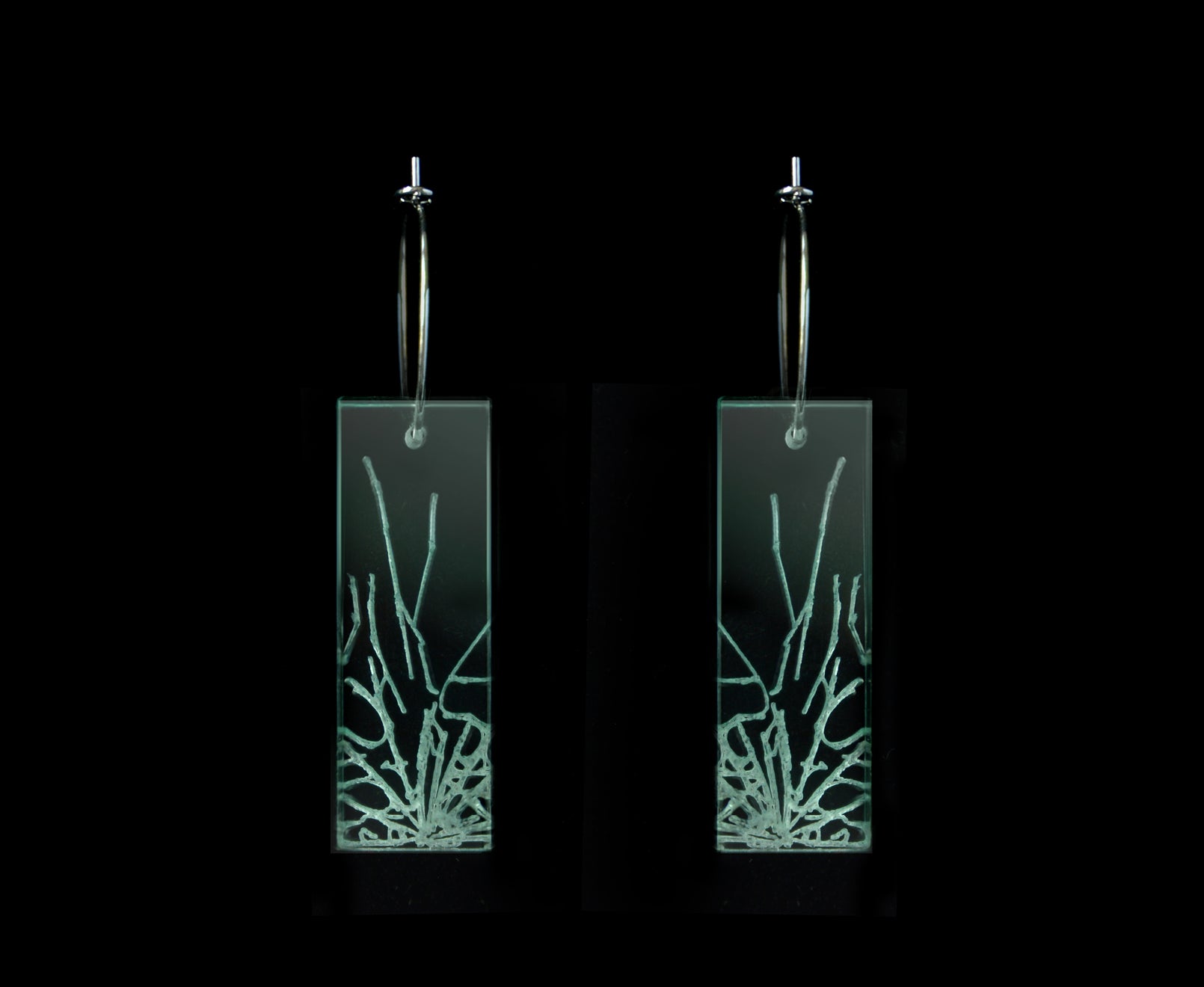 Laser-cut earrings in a shattered glass shape symbolizing gender equality, mid-length rectangle style.